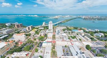 A cityscape with a large body of water in the background.